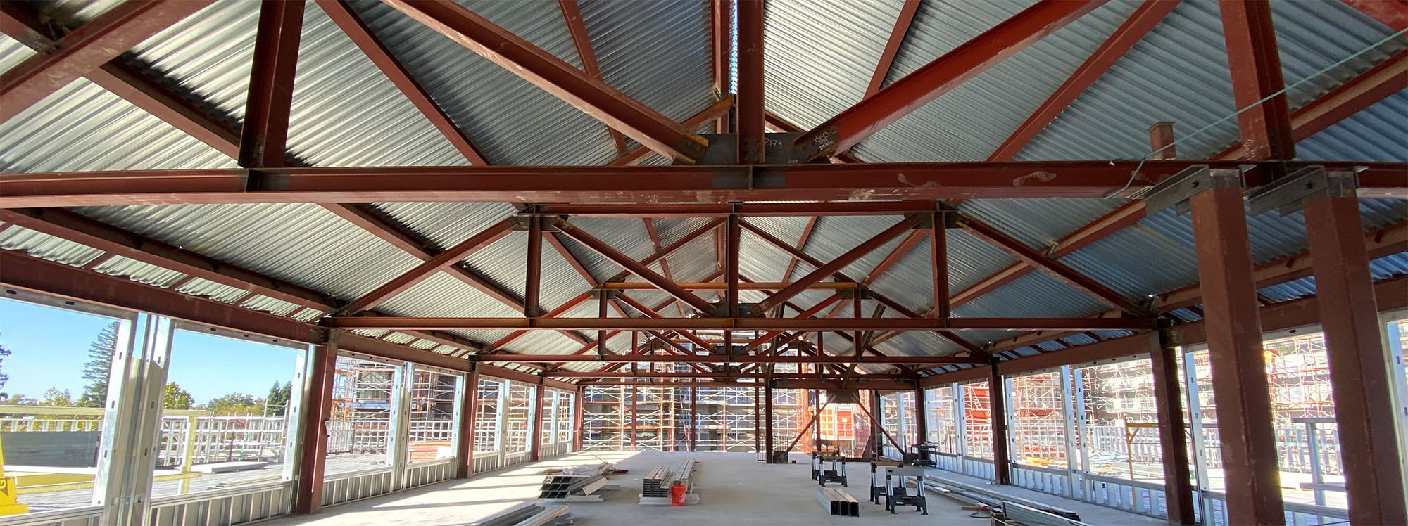 A large metal-frame building in the process of being built