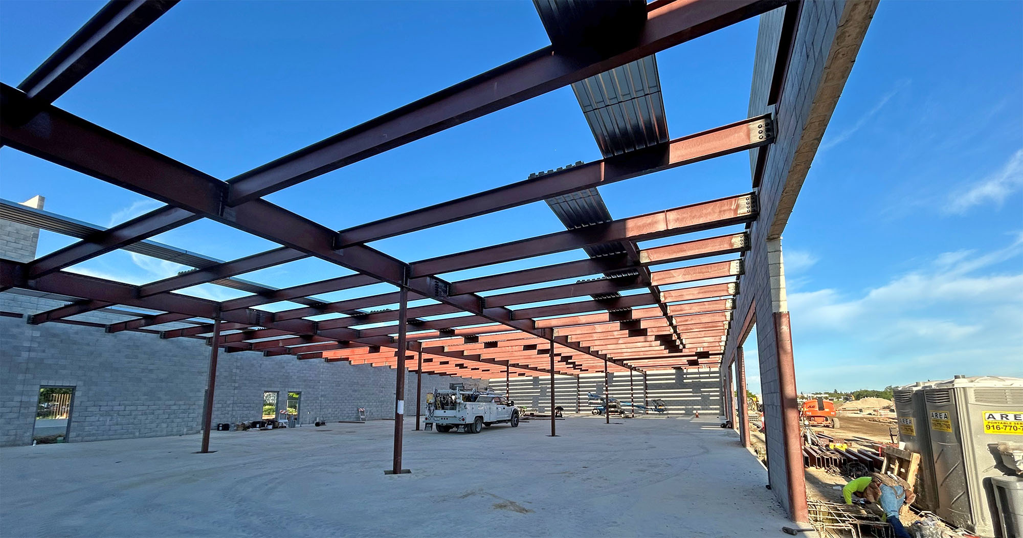A large metal-frame building in the process of being built